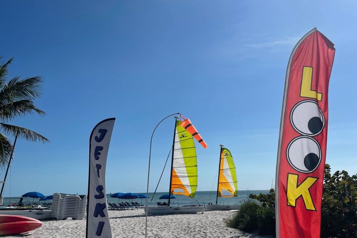 Beach with colorful flags on a sunny day.